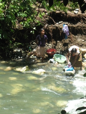 Locals washing clothes in
the river below the falls.